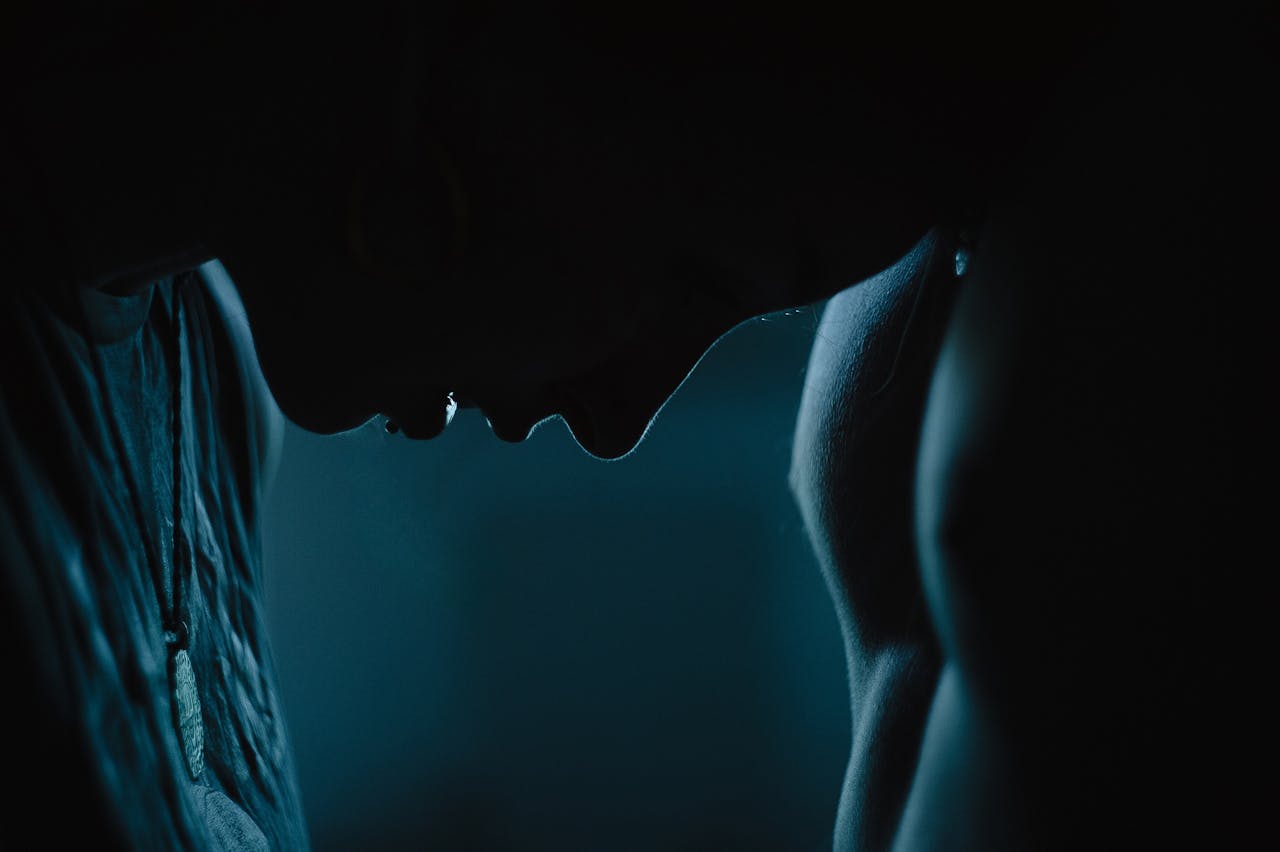 Services-01 Silhouette of a couple facing each other, evoking a sense of emotion and intimacy in a dark, atmospheric setting.